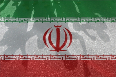 [ai] The flag of Iran, featuring horizontal stripes of green, white, and red, with the national emblem in the center. Shadows of hands are seen above the flag.